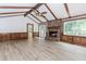 Bright living room featuring a fireplace, wood beams, and wood paneling at 3156 Laurel Way, Snellville, GA 30078