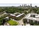 Aerial view showcases brick townhomes nestled among trees with a distant cityscape of Atlanta at 345 Glen Iris Ne Dr # 5, Atlanta, GA 30312