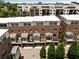 Aerial view of brick townhomes showing garages, trees and patios; city buildings are visible in the distance at 345 Glen Iris Ne Dr # 5, Atlanta, GA 30312
