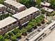 Birds-eye view of brick townhomes surrounded by green trees with rooftops and city street below at 345 Glen Iris Ne Dr # 5, Atlanta, GA 30312