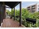 Private outdoor balcony with wooden flooring and wrought iron railings with view of landscaping at 345 Glen Iris Ne Dr # 5, Atlanta, GA 30312