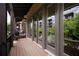 Relaxing outdoor balcony with wood flooring, offering a view of trees and building at 345 Glen Iris Ne Dr # 5, Atlanta, GA 30312