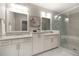 Elegant bathroom featuring double sinks and a glass-enclosed shower with a tub at 345 Glen Iris Ne Dr # 5, Atlanta, GA 30312