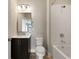 Bathroom features tile shower, dark vanity with marble countertop, and hardwood floors at 345 Glen Iris Ne Dr # 5, Atlanta, GA 30312
