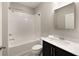 Bright bathroom features white subway tile surround, a tub with shower, and black vanity with marble counter at 345 Glen Iris Ne Dr # 5, Atlanta, GA 30312