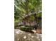 Brick townhome with manicured landscaping and shade trees lining a sidewalk near the entrance at 345 Glen Iris Ne Dr # 5, Atlanta, GA 30312