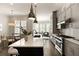 Open kitchen featuring white countertop island with bar seating, stainless appliances, subway tile backsplash and views of Gathering room at 345 Glen Iris Ne Dr # 5, Atlanta, GA 30312