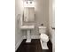 Modern half bath with pedestal sink and dark wood floors at 345 Glen Iris Ne Dr # 5, Atlanta, GA 30312