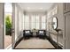 Cozy sitting room featuring bright windows with custom blinds, hardwood floors, modern furniture and access to deck at 345 Glen Iris Ne Dr # 5, Atlanta, GA 30312