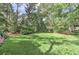 The large backyard features lush green grass and mature trees at 4920 Tremont Ne Dr, Marietta, GA 30066