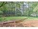 The backyard has a large grassy area, mature trees, and natural landscaping at 4920 Tremont Ne Dr, Marietta, GA 30066