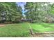 Spacious backyard featuring lush green grass and mature trees at 4920 Tremont Ne Dr, Marietta, GA 30066