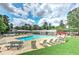 The community pool is surrounded by lush green grass, lounge chairs, and picnic tables at 4920 Tremont Ne Dr, Marietta, GA 30066