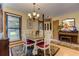 Inviting dining area with a chandelier, window and decoratively furnished with a piano at 4920 Tremont Ne Dr, Marietta, GA 30066