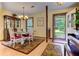 Cozy dining room featuring a chandelier, wood table with white chairs, and decorative rug at 4920 Tremont Ne Dr, Marietta, GA 30066