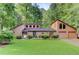 Charming home featuring a 2-car garage, well-manicured lawn, and mature trees at 4920 Tremont Ne Dr, Marietta, GA 30066