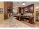 A kitchen highlighting dark wood cabinets, granite countertops, stainless steel appliances, and wooden floors at 4920 Tremont Ne Dr, Marietta, GA 30066