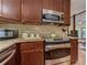 A kitchen featuring dark wood cabinets, granite countertops, stainless steel appliances, and wooden floors at 4920 Tremont Ne Dr, Marietta, GA 30066