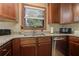 A kitchen showcasing dark wood cabinets, granite countertops, stainless steel appliances, and wooden floors at 4920 Tremont Ne Dr, Marietta, GA 30066