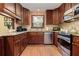 A kitchen showcasing dark wood cabinets, granite countertops, stainless steel appliances, and wooden floors at 4920 Tremont Ne Dr, Marietta, GA 30066