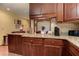 A kitchen featuring dark wood cabinets, granite countertops, stainless steel appliances, and wooden floors at 4920 Tremont Ne Dr, Marietta, GA 30066