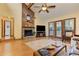 Inviting living room with a stone fireplace, wood-paneled accent wall, and natural light at 4920 Tremont Ne Dr, Marietta, GA 30066