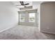 Spacious bedroom features neutral carpet, two windows, and a ceiling fan at 1005 Bayrose Cir # 5A, Atlanta, GA 30344