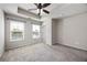 Large bedroom featuring neutral carpet, two windows, recessed ceiling and ceiling fan at 1005 Bayrose Cir # 5A, Atlanta, GA 30344