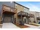 Three-story townhomes with elevated decks and attached garages on a sunny day at 1005 Bayrose Cir # 5A, Atlanta, GA 30344