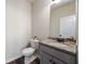 Stylish half bathroom with granite countertop vanity and wood-look flooring at 1005 Bayrose Cir # 5A, Atlanta, GA 30344