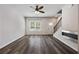 Cozy living room featuring electric fireplace, hardwood flooring, large window, and bright entry door at 1005 Bayrose Cir # 5A, Atlanta, GA 30344