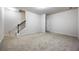 Spacious living room boasts neutral carpet, white walls, and stairway access to upper level at 1005 Bayrose Cir # 5A, Atlanta, GA 30344