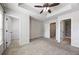 A spacious main bedroom with two entryways, carpet flooring, and a ceiling fan at 1005 Bayrose Cir # 5A, Atlanta, GA 30344