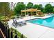 Community pool with sun loungers and pergola at 1005 Bayrose Cir # 5A, Atlanta, GA 30344
