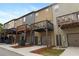 Townhome exteriors featuring driveways and elevated wooden decks on the upper level at 1005 Bayrose Cir, Atlanta, GA 30344