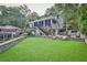 Expansive backyard features a well-maintained lawn, a stone retaining wall, and a spacious porch at 1658 E Clifton Ne Rd, Atlanta, GA 30307