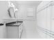 Bright bathroom featuring a double vanity with black granite countertop and a shower with blue accents at 1658 E Clifton Ne Rd, Atlanta, GA 30307