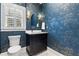 Stylish powder room with patterned wallpaper, modern fixtures, and natural light at 1658 E Clifton Ne Rd, Atlanta, GA 30307