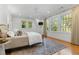 Spacious bedroom with large windows offering lush outdoor views and wooden floors at 1658 E Clifton Ne Rd, Atlanta, GA 30307