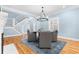 Bright dining area featuring hardwood floors, chandelier, and views of staircase and shuttered windows at 1658 E Clifton Ne Rd, Atlanta, GA 30307