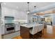 Bright kitchen with stainless appliances, white cabinets and central island with a marble countertop and stylish pendant lights at 1658 E Clifton Ne Rd, Atlanta, GA 30307