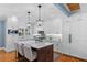 Bright kitchen with white cabinets, marble countertops, stainless steel appliances, and a central island at 1658 E Clifton Ne Rd, Atlanta, GA 30307