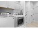 Laundry room with modern front-load washer and dryer units with cabinets and storage at 1658 E Clifton Ne Rd, Atlanta, GA 30307