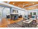 Open-concept living room with hardwood floors, exposed brick fireplace, and seamless transition to the kitchen at 1658 E Clifton Ne Rd, Atlanta, GA 30307