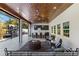 Covered outdoor living space with seating area, ceiling fan, and an outdoor kitchen and bar setup at 1658 E Clifton Ne Rd, Atlanta, GA 30307