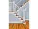 Classic staircase with white railings, oak steps, and blue accent wall at 1658 E Clifton Ne Rd, Atlanta, GA 30307