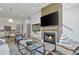 Inviting living room with modern fireplace, hardwood floors, and open layout to kitchen and dining area at 190 Rolison Way, Fayetteville, GA 30214