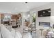 Open-concept living space featuring a modern fireplace, kitchen, and dining area at 200 Maycrest Path, Tucker, GA 30084