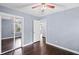 Bedroom featuring hardwood floors, ceiling fan, and an open layout at 881 Mclinden Se Ave, Smyrna, GA 30080