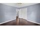 A well-lit bedroom with hardwood floors, a ceiling fan, and a closet at 881 Mclinden Se Ave, Smyrna, GA 30080